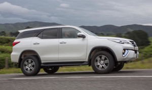 Fortuner GXL Exterior - Crystal Pearl - side profile driving on the open road